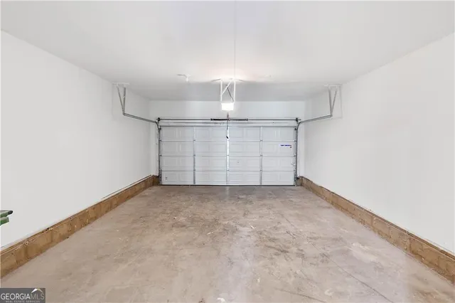 an empty room with chandelier fan