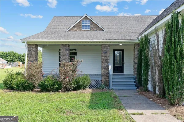 a front view of a house with garden