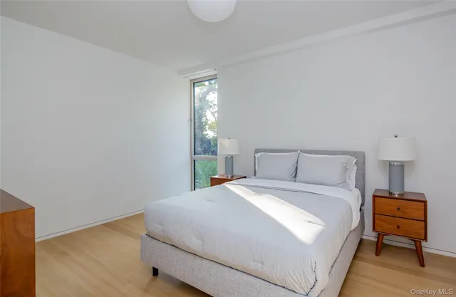 a bedroom with a bed and a night stand