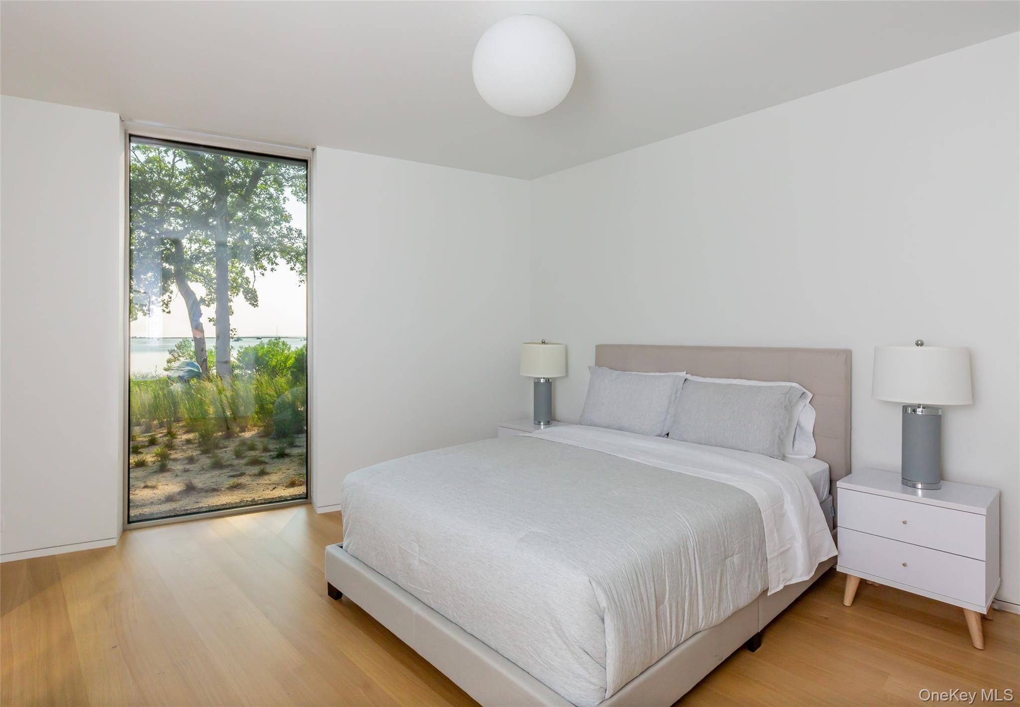47 L South Ferry Road Shelter Island, NY 11964 - Photo 21 of 38 a bedroom with a bed and window