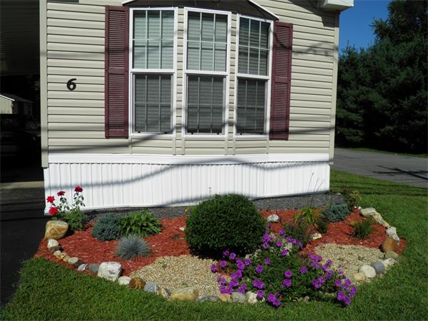 a view of a house with a yard and garden