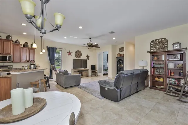 a living room with furniture and a kitchen