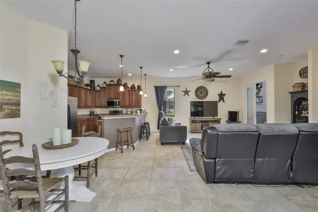 a living room with furniture a dining table and kitchen view