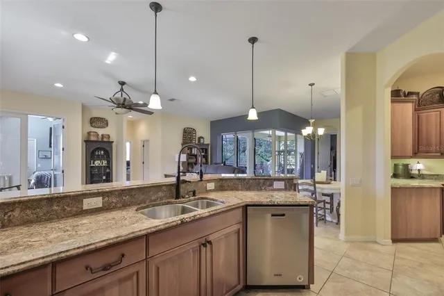 a kitchen with a sink and chandelier
