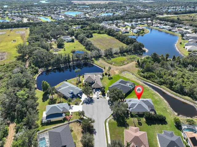 an aerial view of residential houses with outdoor space and swimming pool