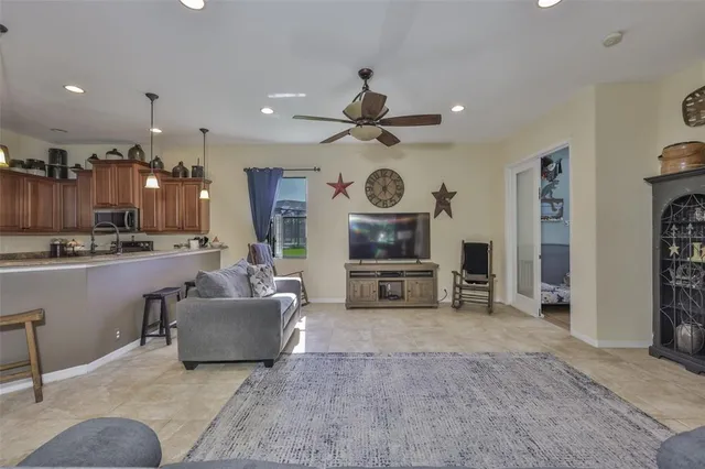 a living room with furniture and kitchen view