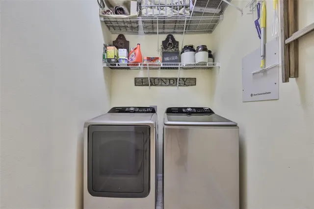a bedroom with a bed a window and a flat screen tv