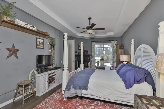 a bedroom with a bed and a mirror on dresser