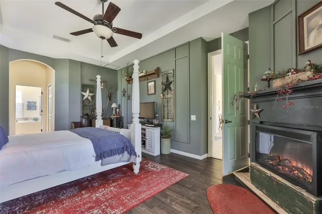 a spacious bedroom with a bed and a chandelier