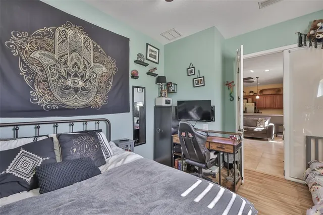 a bedroom with a bed and wooden floor