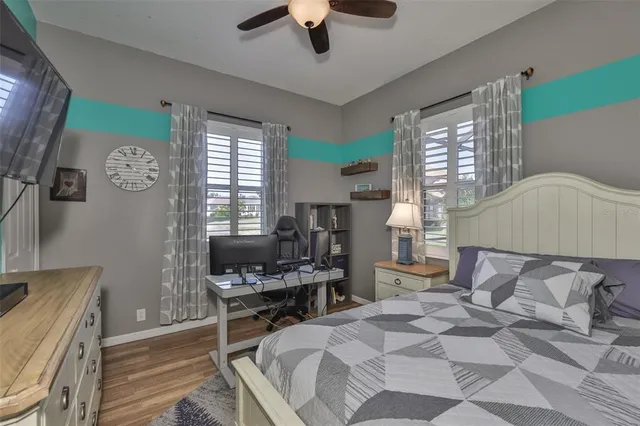 a bedroom with a bed and flat screen tv