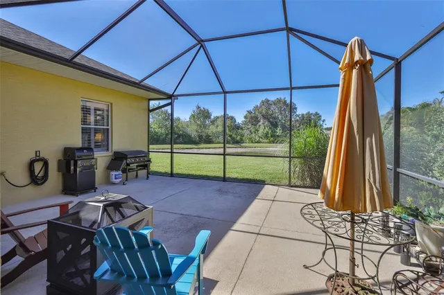 a swimming pool with outdoor seating and yard