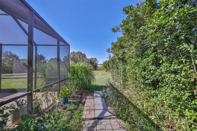 a view of a green field with trees in the background