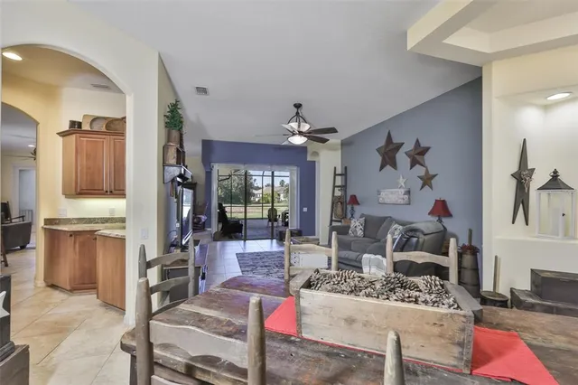 a living room with furniture and a kitchen view