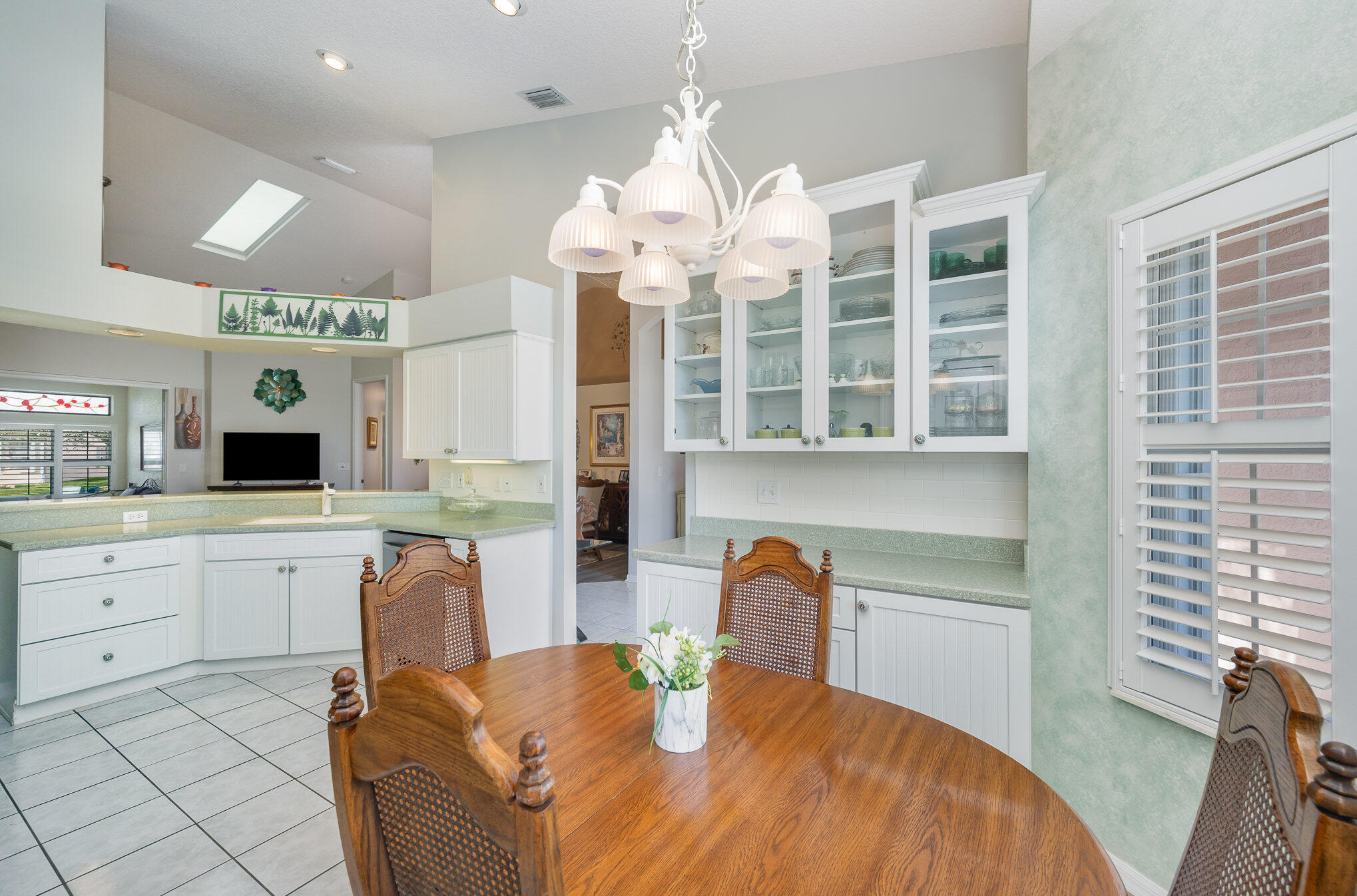 391 Shell Cove Drive Melbourne, FL 32940 - Photo 12 of 37 a kitchen with a sink dining table and chairs