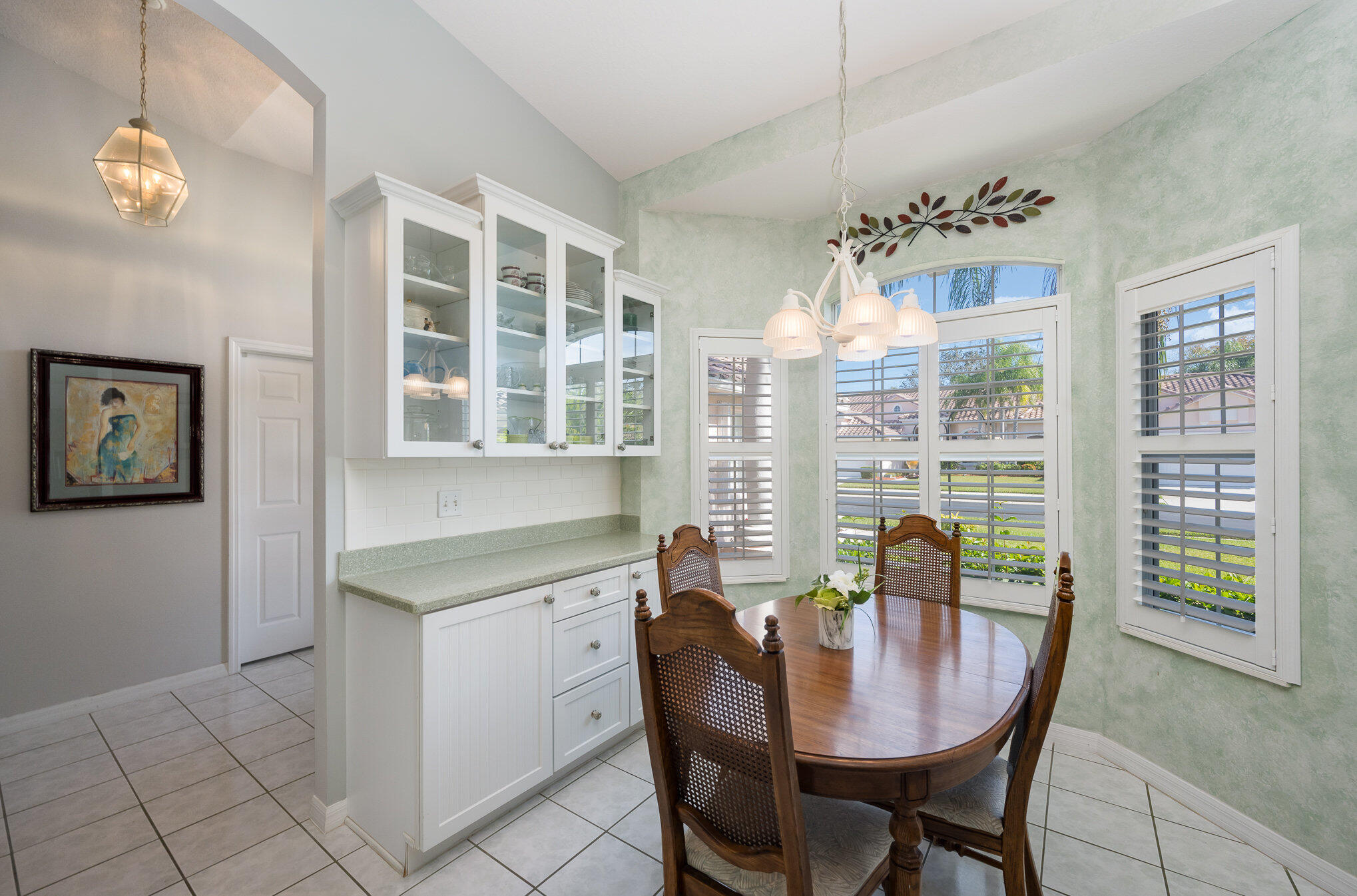391 Shell Cove Drive Melbourne, FL 32940 - Photo 13 of 37 a view of a dining room with furniture large windows and wooden floor