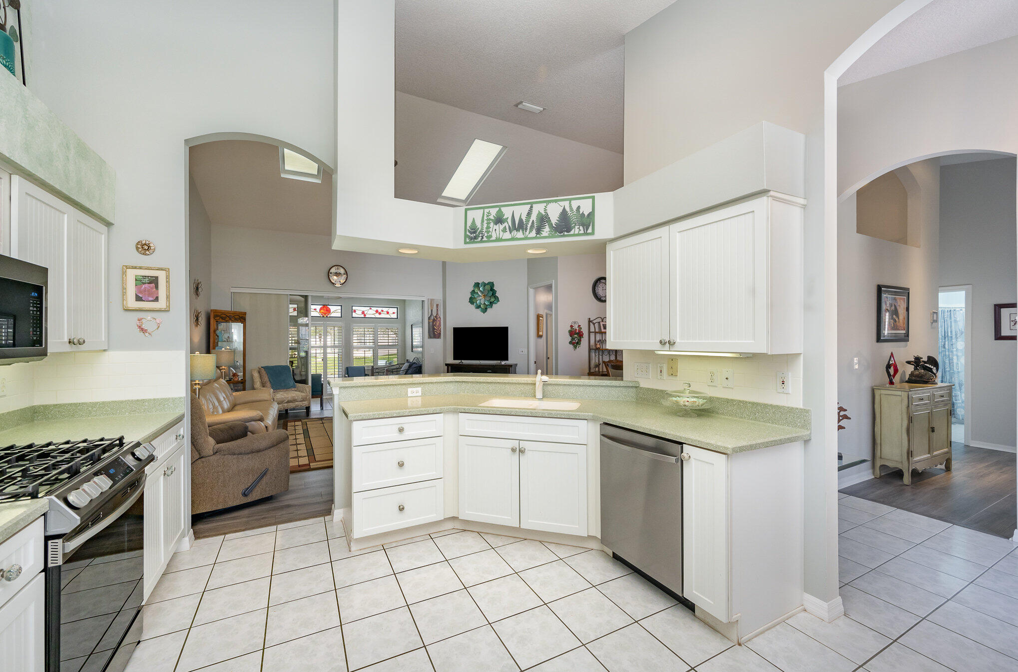 391 Shell Cove Drive Melbourne, FL 32940 - Photo 15 of 37 a kitchen with a stove sink and cabinets