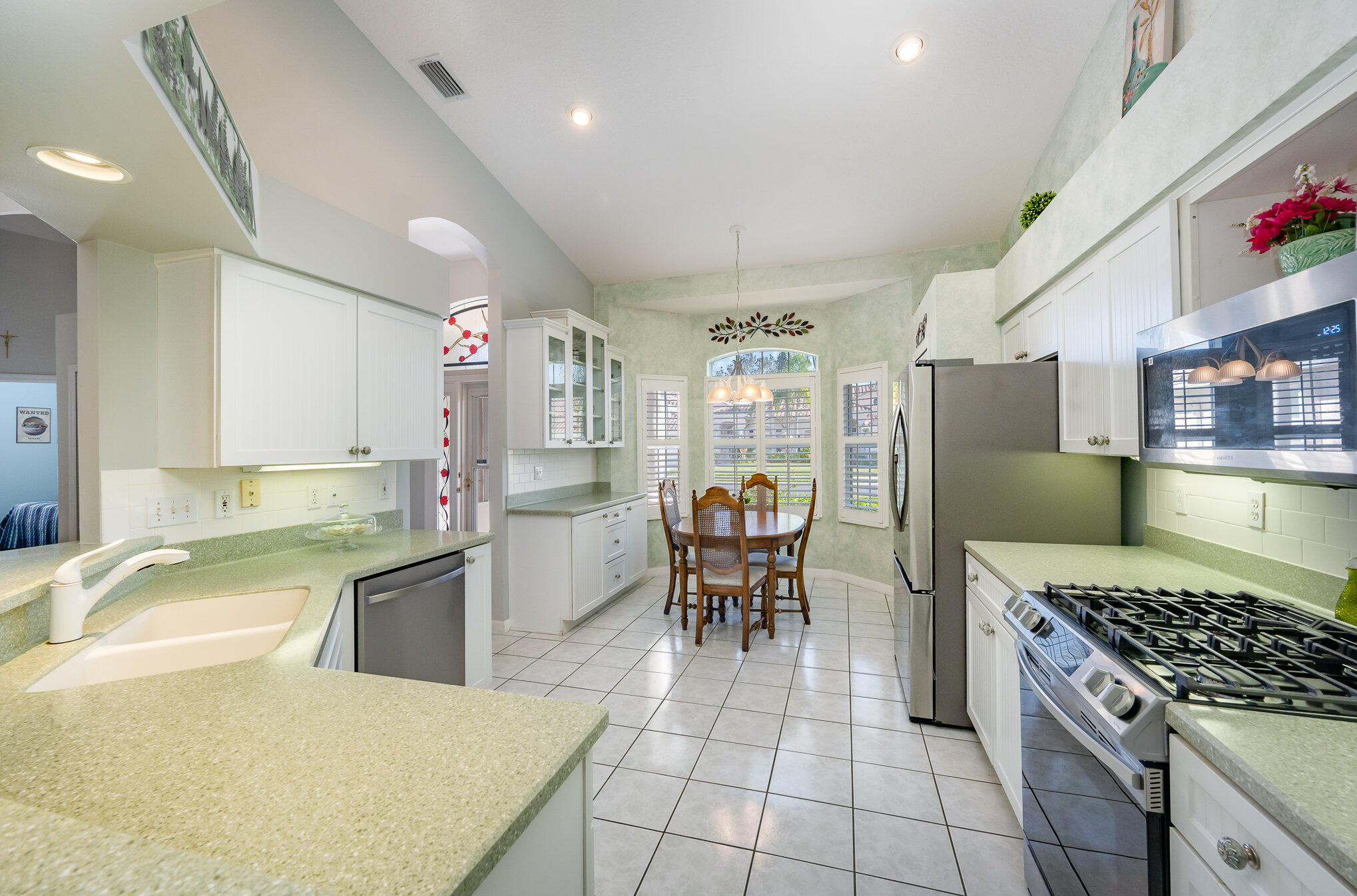 391 Shell Cove Drive Melbourne, FL 32940 - Photo 16 of 37 a kitchen with granite countertop a sink appliances and cabinets
