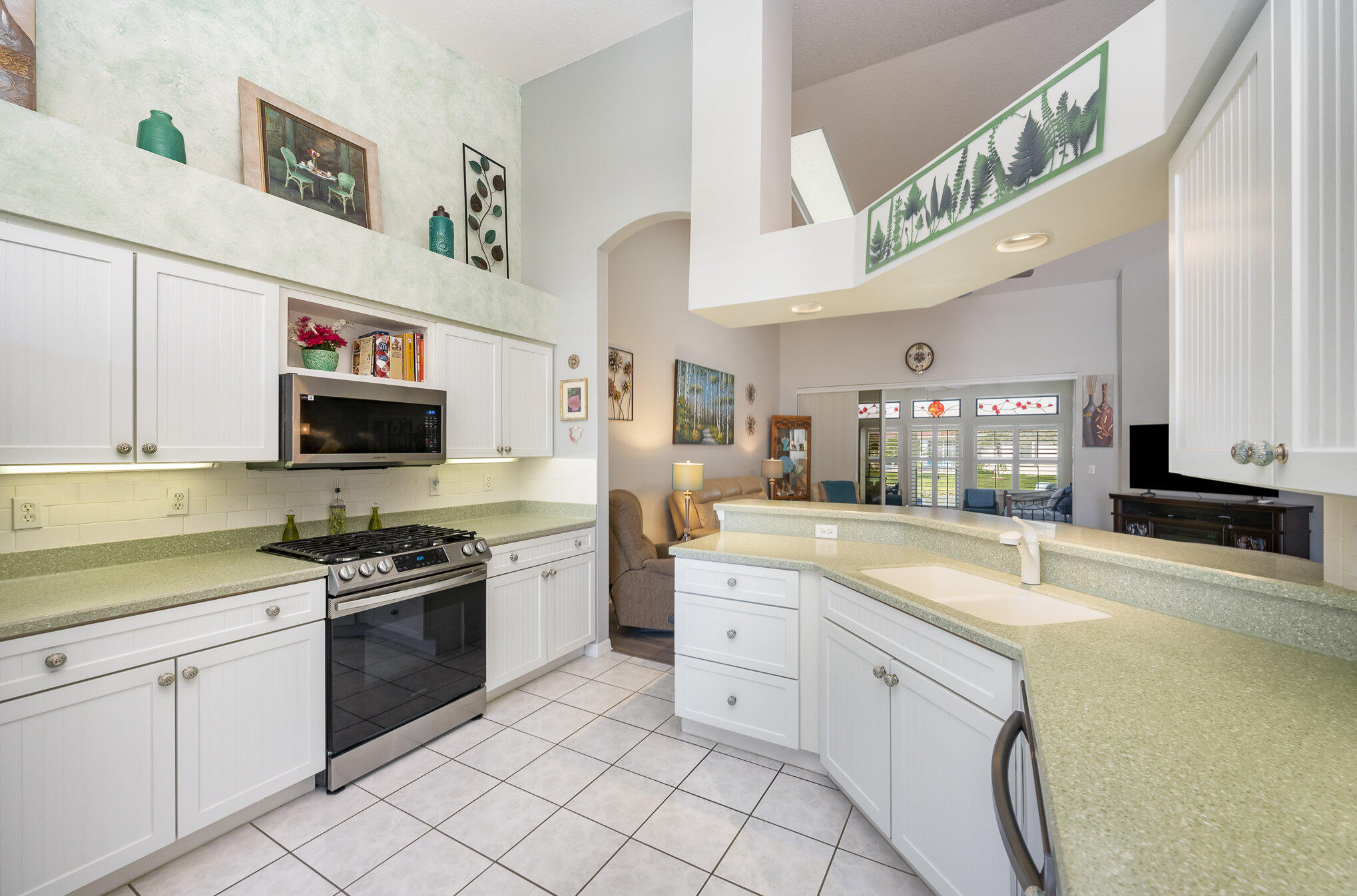 391 Shell Cove Drive Melbourne, FL 32940 - Photo 17 of 37 a kitchen with stainless steel appliances granite countertop a sink and a stove