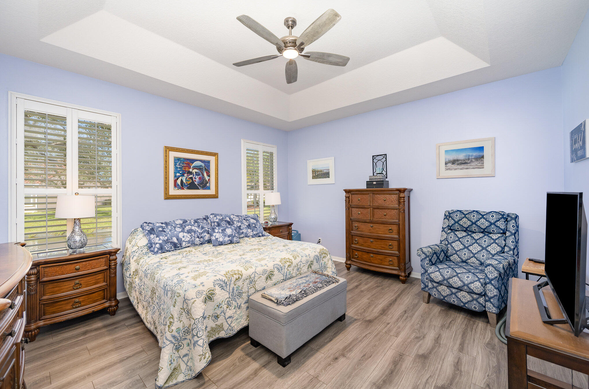 391 Shell Cove Drive Melbourne, FL 32940 - Photo 18 of 37 a bedroom with a bed dresser and wooden floor