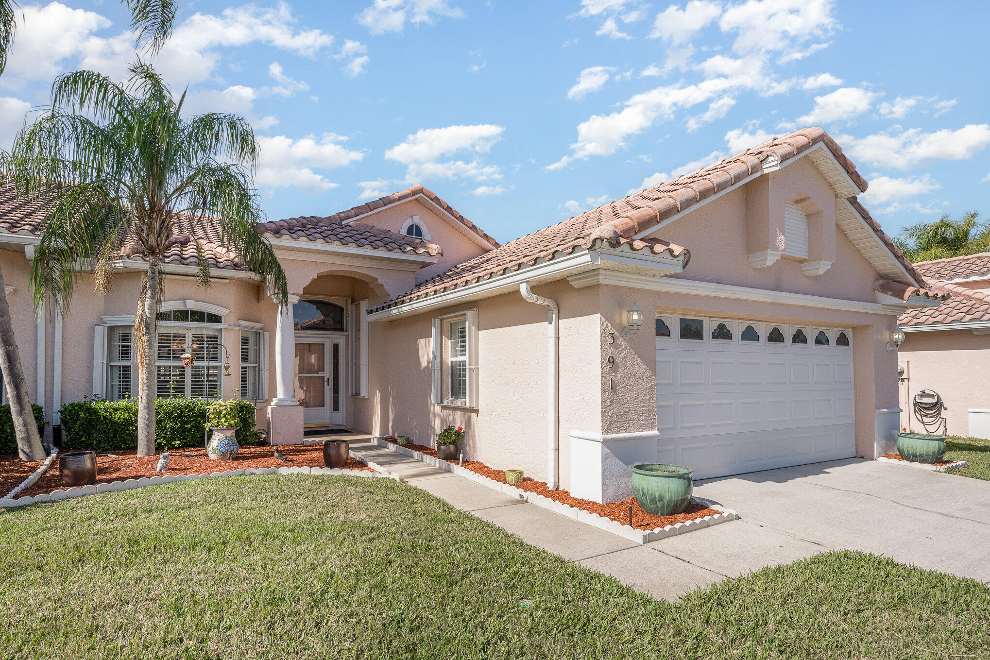 391 Shell Cove Drive Melbourne, FL 32940 - Photo 2 of 37 a front view of a house with garden