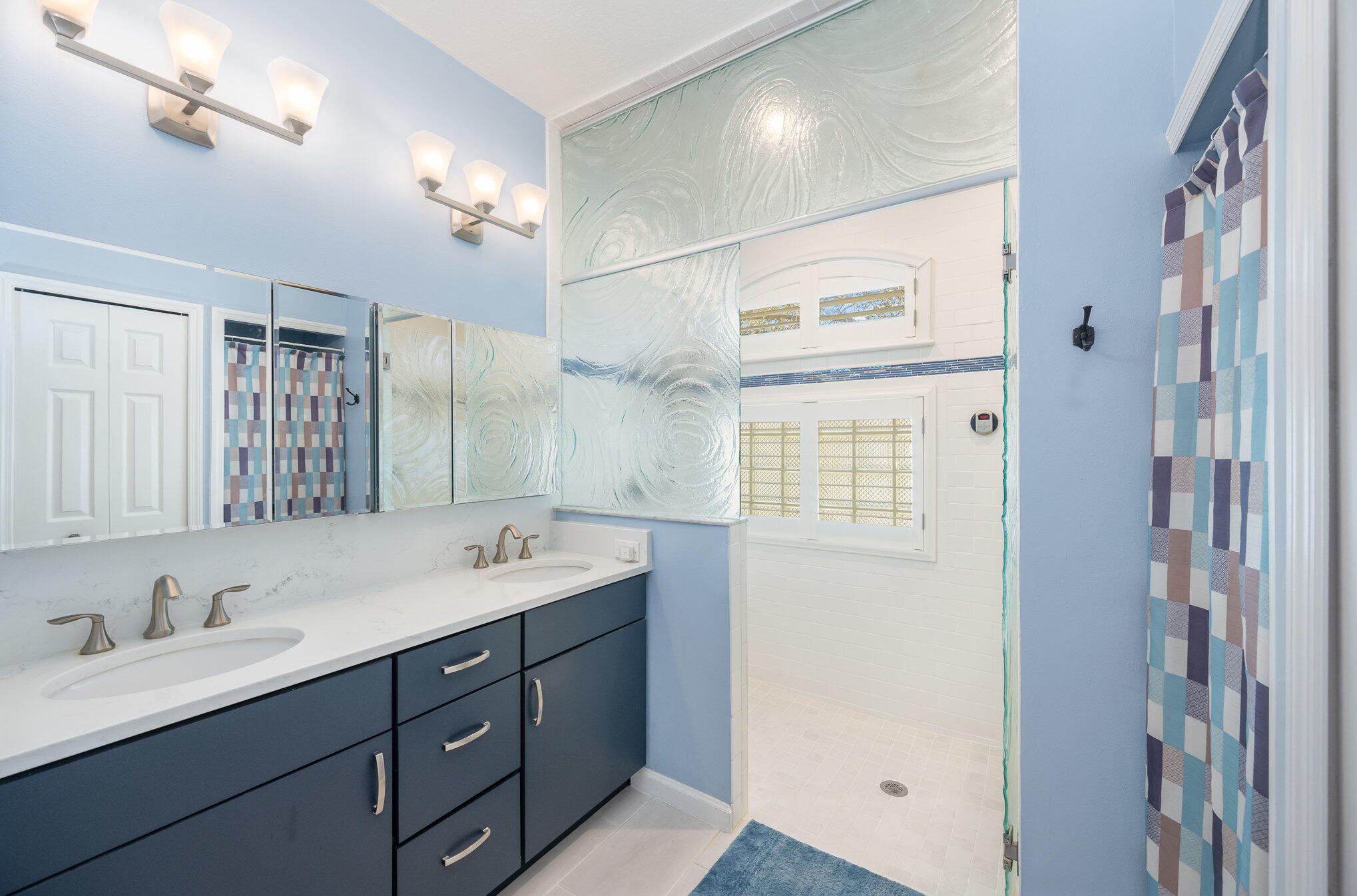 391 Shell Cove Drive Melbourne, FL 32940 - Photo 21 of 37 a bathroom with double vanity sink a mirror and a shower