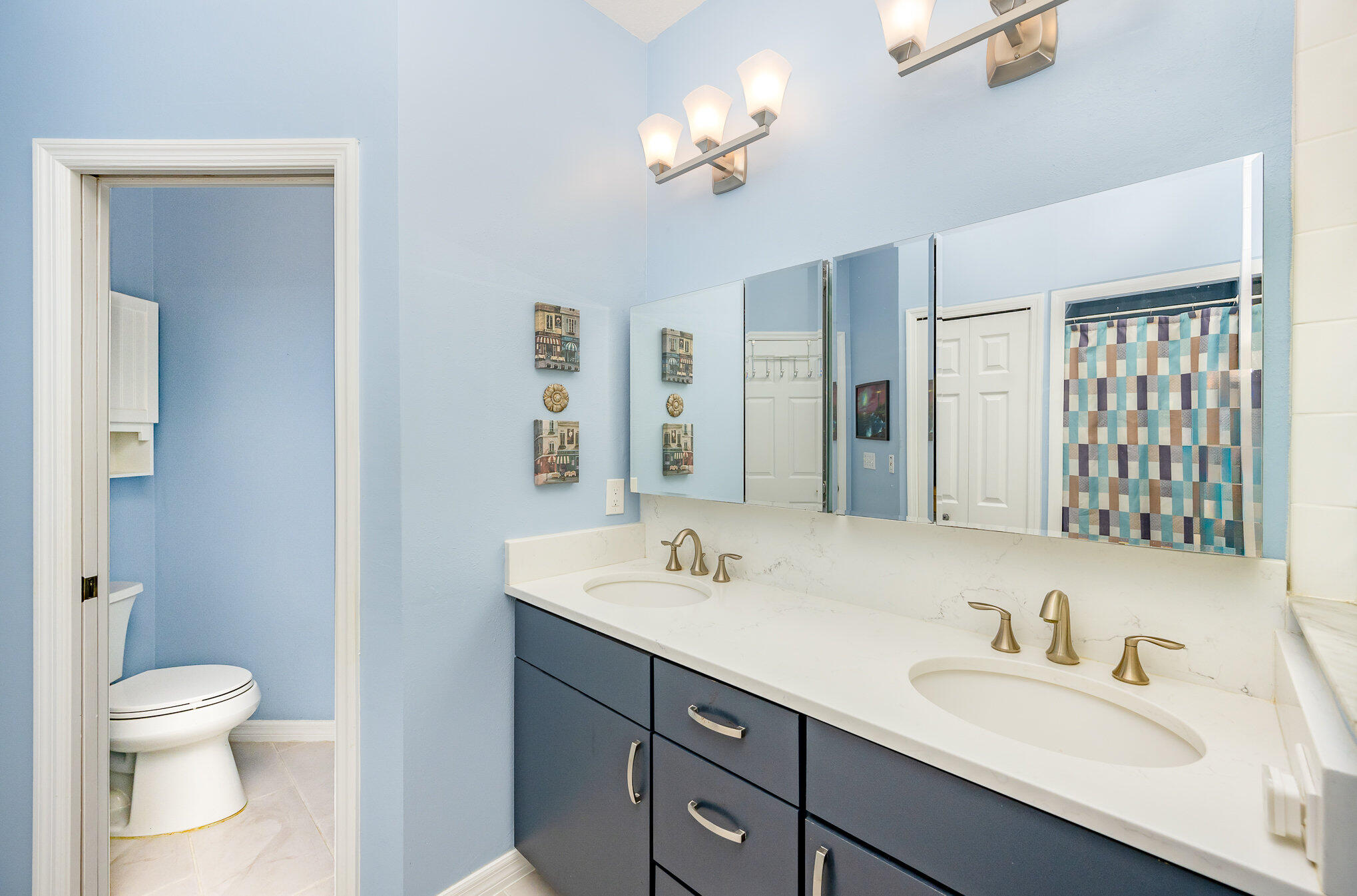 391 Shell Cove Drive Melbourne, FL 32940 - Photo 23 of 37 a bathroom with a granite countertop sink a toilet and a mirror