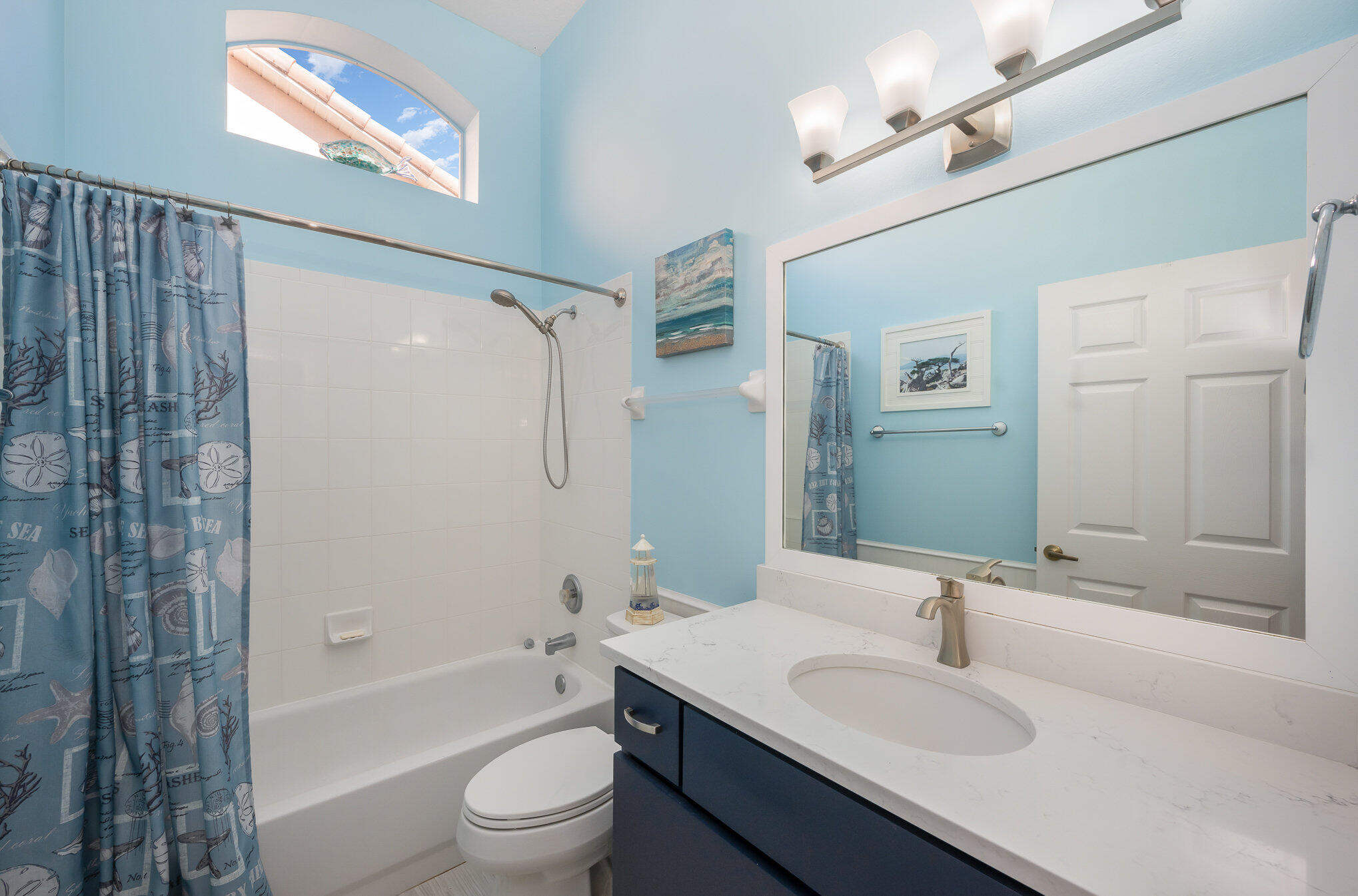 391 Shell Cove Drive Melbourne, FL 32940 - Photo 27 of 37 a bathroom with a granite countertop sink toilet a shower and a mirror
