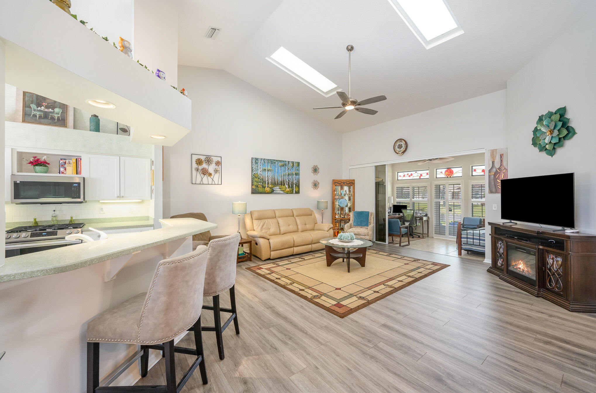 391 Shell Cove Drive Melbourne, FL 32940 - Photo 5 of 37 a living room with fireplace furniture and a flat screen tv