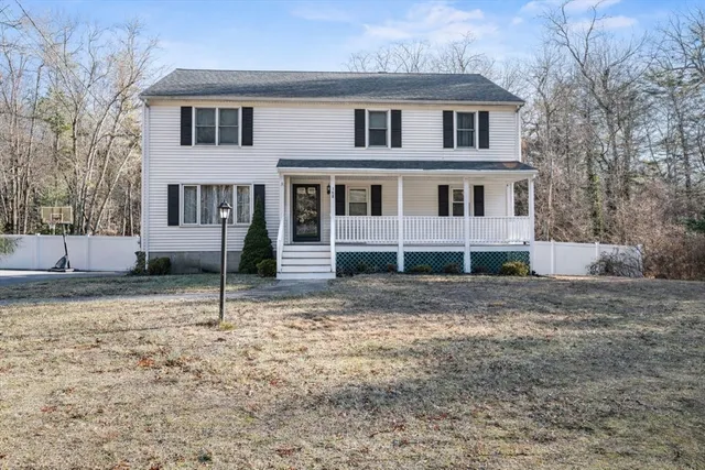 a view of a house with a yard and sitting area