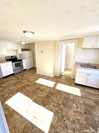 a living room with furniture and kitchen view