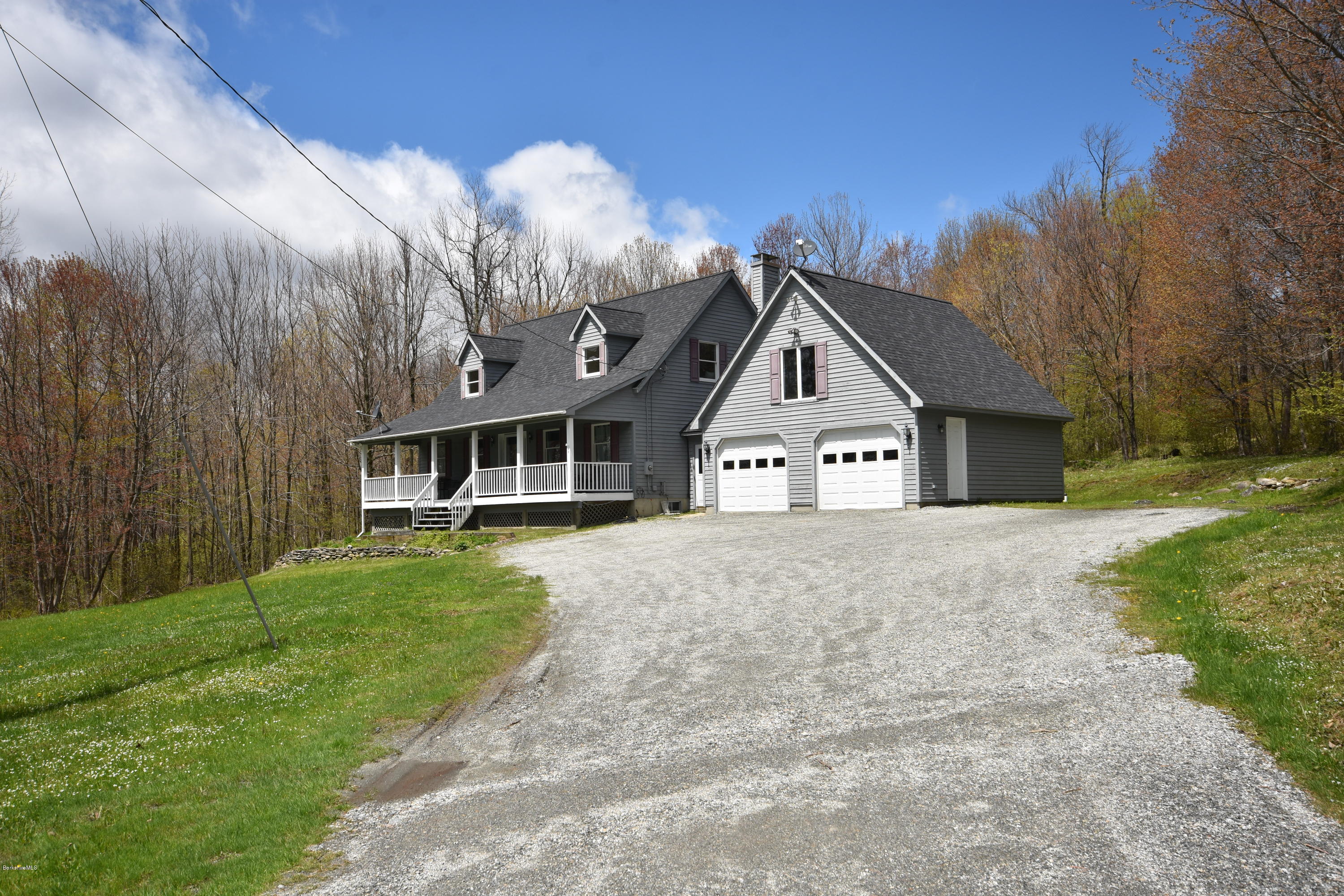 1246 Jacobs Ladder Road Becket, MA 01223 - Photo 3 of 54 a front view of a house with a yard and garage