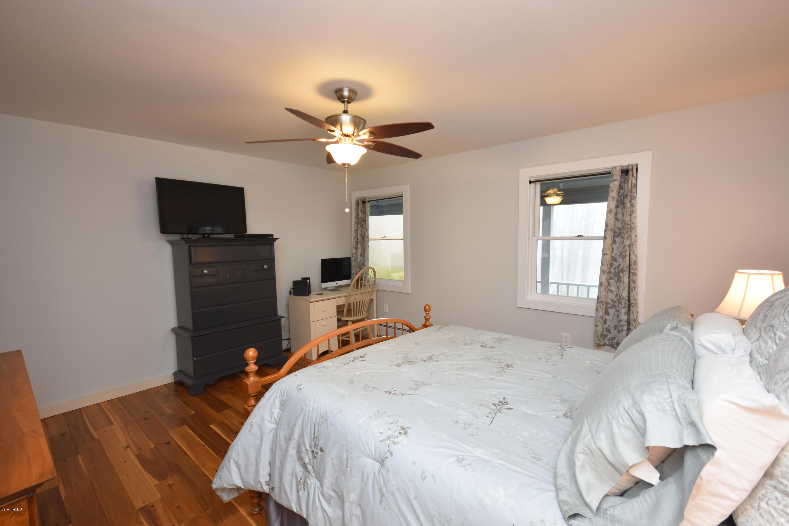 1246 Jacobs Ladder Road Becket, MA 01223 - Photo 22 of 54 a bedroom with a bed and a flat screen tv