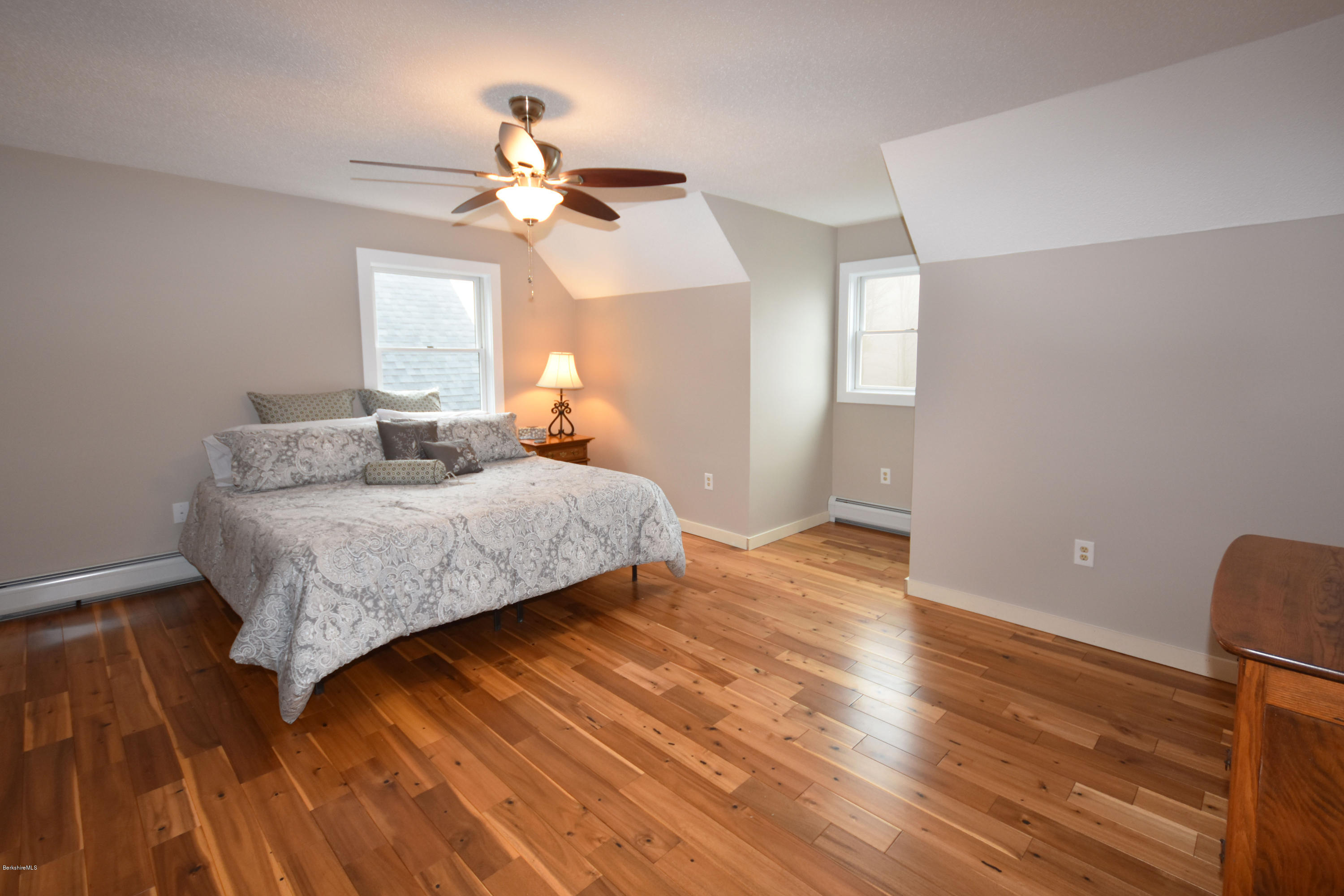 1246 Jacobs Ladder Road Becket, MA 01223 - Photo 29 of 54 a bedroom with wooden floor and a ceiling fan