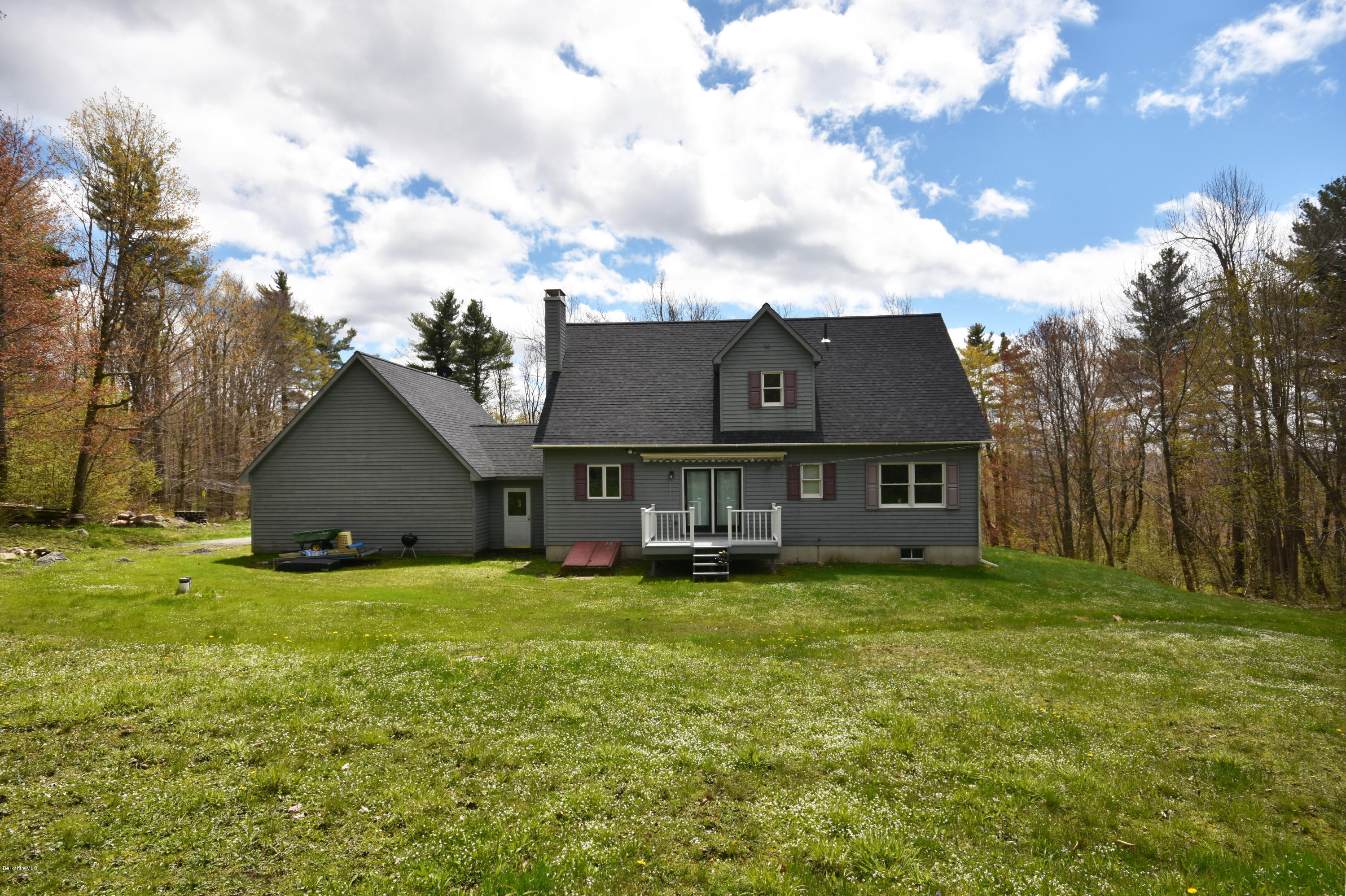 1246 Jacobs Ladder Road Becket, MA 01223 - Photo 49 of 54 a view of a house with a big yard and a large tree