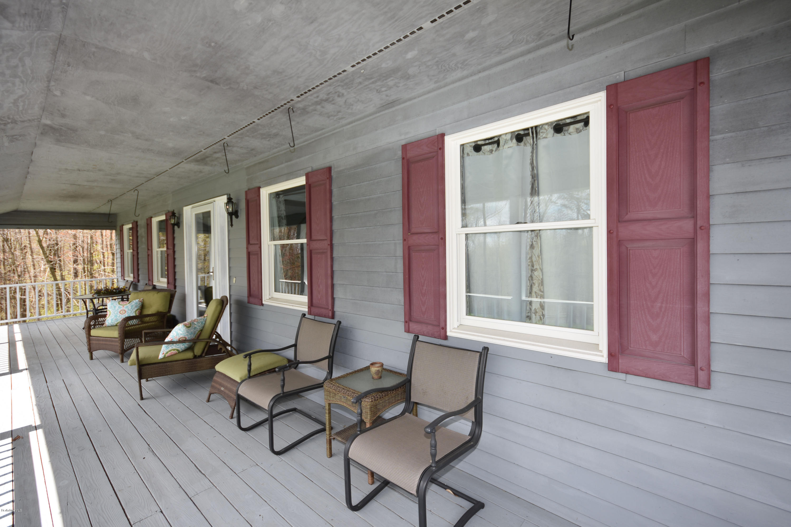 1246 Jacobs Ladder Road Becket, MA 01223 - Photo 7 of 54 a living room with furniture and floor to ceiling windows