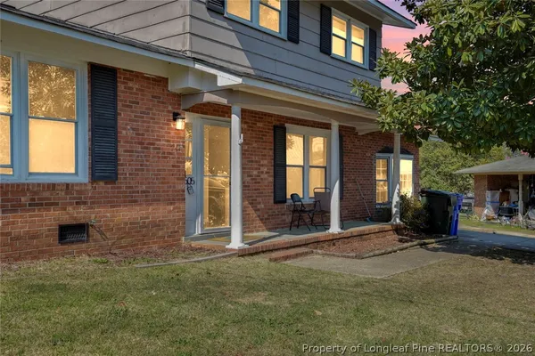 a view of a brick house with a large windows