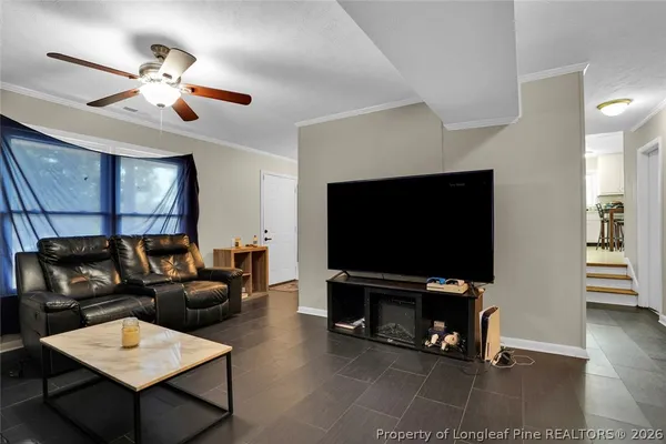 a kitchen with stainless steel appliances kitchen island granite countertop a refrigerator a stove a dining table and chairs with wooden floor