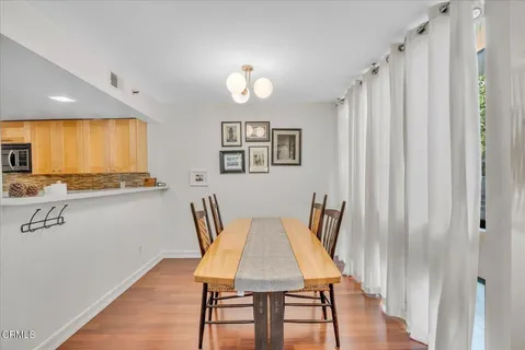a view of a dining room with furniture and wooden floor