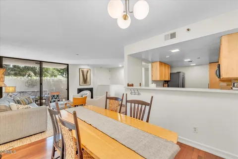 a view of a dining room with furniture wooden floor and chandelier