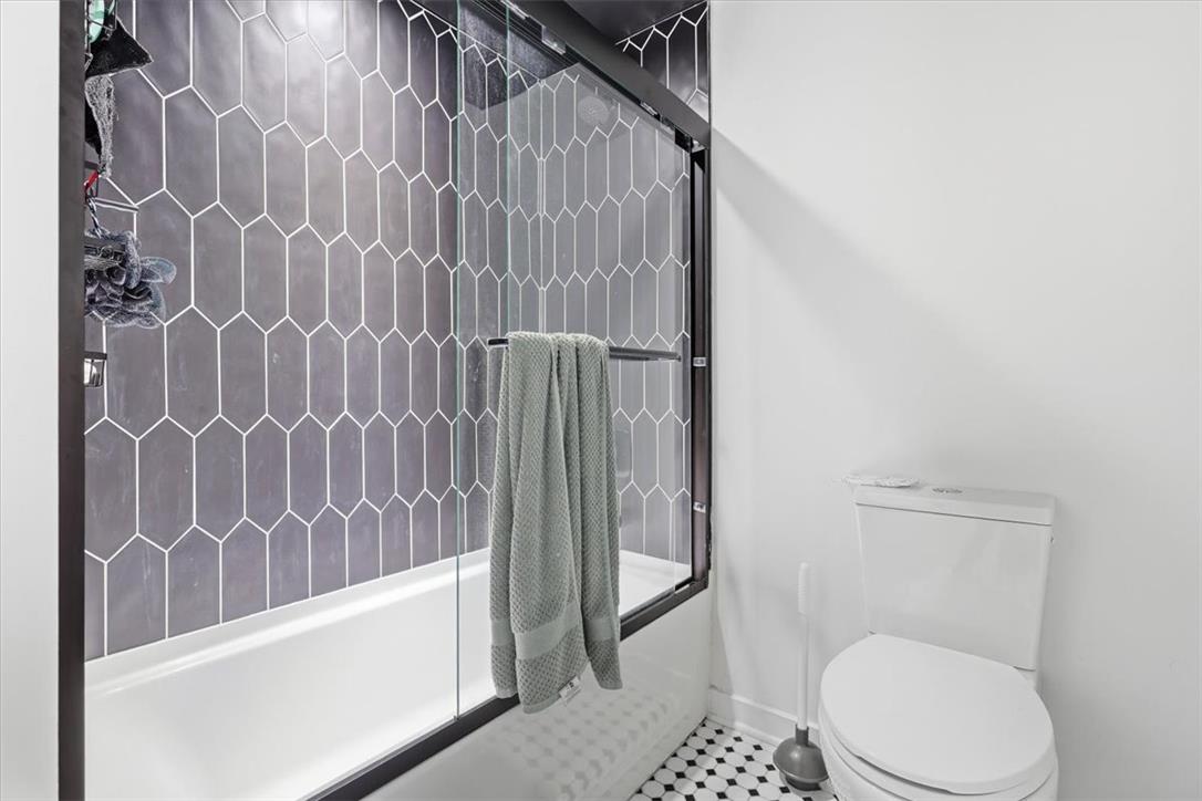 2930 Oakland Road Bethlehem, PA 18017 - Photo 34 of 55 A modern glass-enclosed tub shower highlights picket wall tile and classic mosaic flooring.