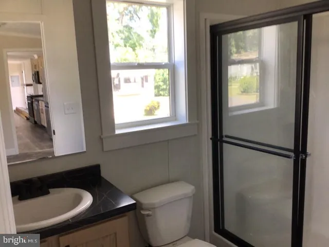 a bathroom with a toilet a sink and a window