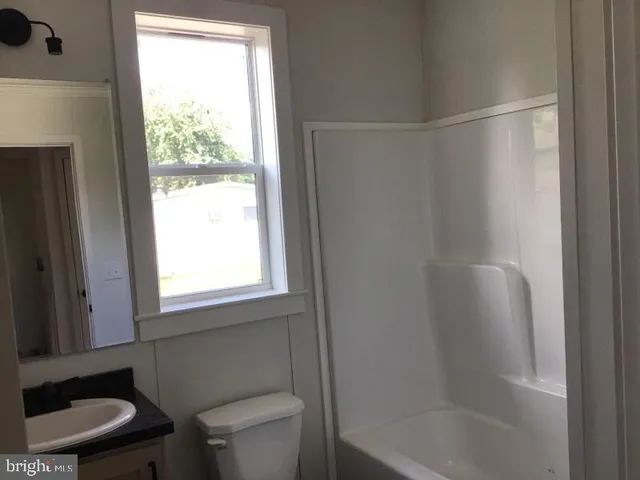 a bathroom with a bathtub toilet and sink