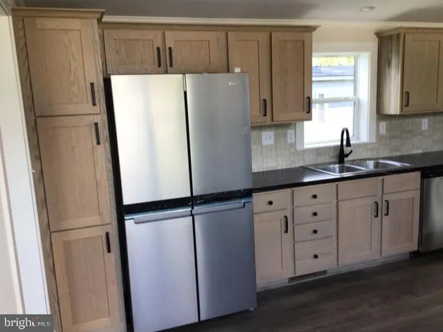 a white refrigerator freezer sitting in a kitchen
