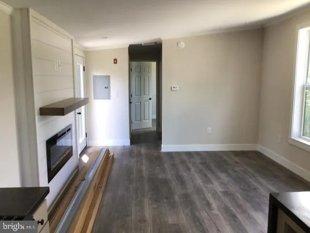 a view of kitchen with sink and refrigerator