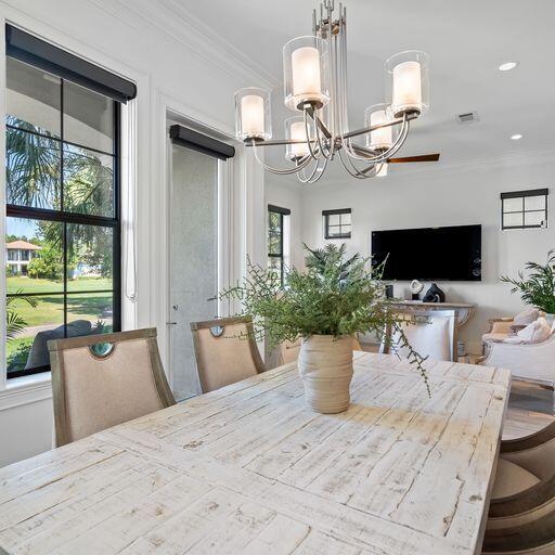 1922 Baytowne Loop Miramar Beach, FL 32550 - Photo 13 of 55 a view of a dining room with furniture a flat screen tv and a chandelier