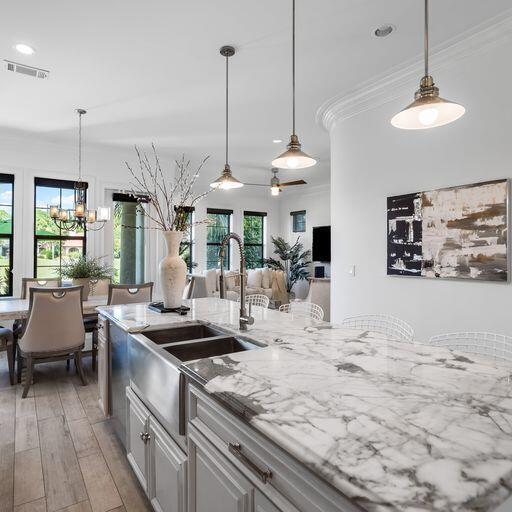 1922 Baytowne Loop Miramar Beach, FL 32550 - Photo 8 of 55 a kitchen with stainless steel appliances kitchen island granite countertop a table and chairs in it