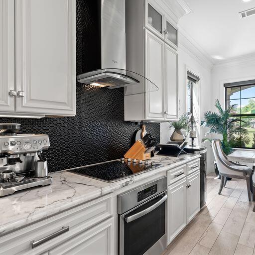 1922 Baytowne Loop Miramar Beach, FL 32550 - Photo 9 of 55 a kitchen with a stove and white cabinets
