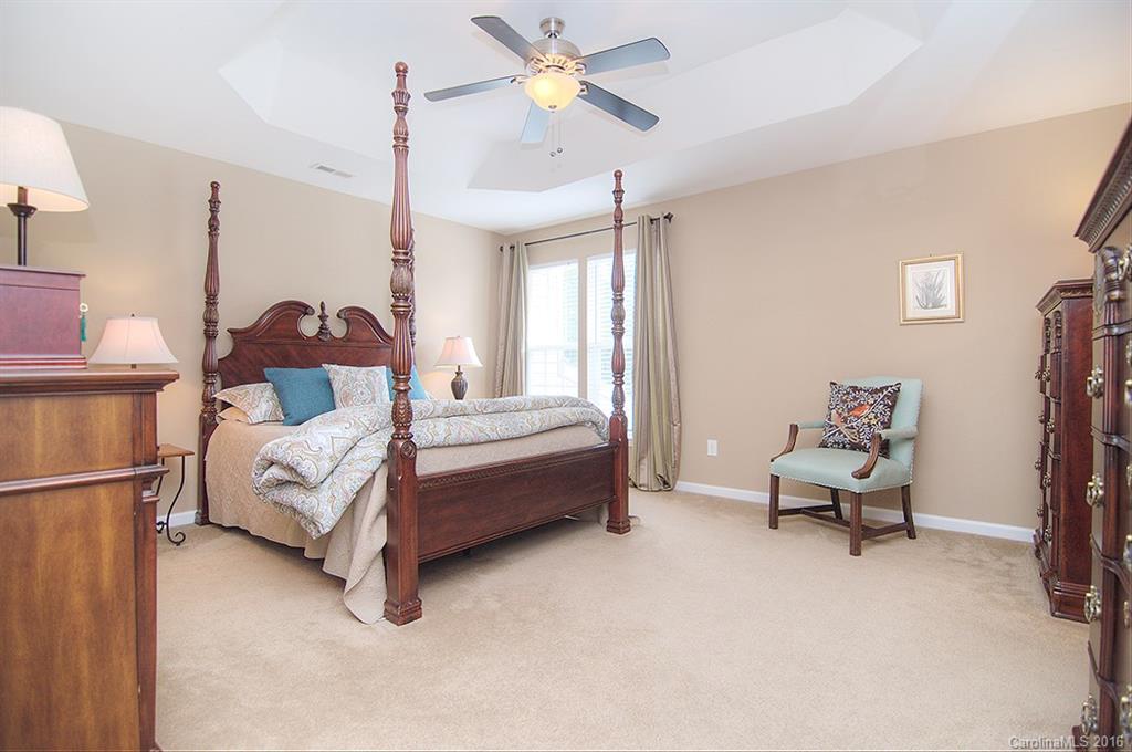 163 Snead Road, Unit 163 Fort Mill, SC 29715 - Photo 12 of 24 a bedroom with furniture and a chandelier