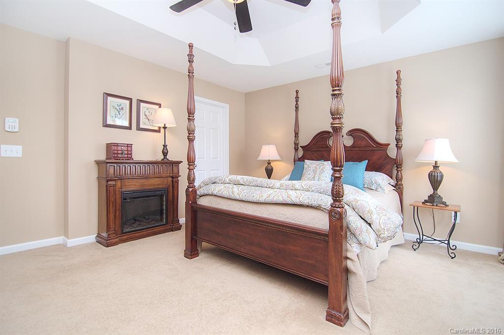 163 Snead Road, Unit 163 Fort Mill, SC 29715 - Photo 13 of 24 a bedroom with a bed and a chandelier